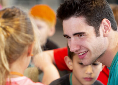 Kidmin leader talking with children about disabilities.