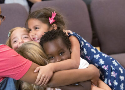 Children's ministry leader who knows how to teach kids about Passover. She tells kids that God cares for them after the London Bridge activity.