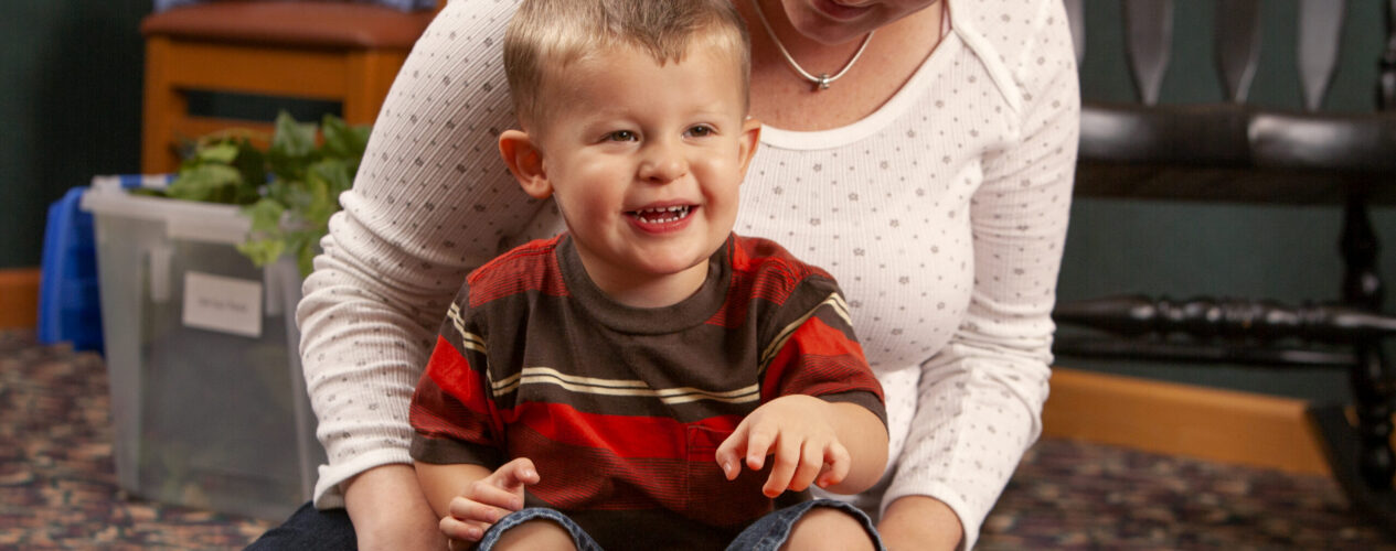 Teacher teaching a baby in a church nursery that Holy Spirit offers power from God.