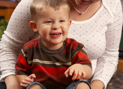 Teacher teaching a baby in a church nursery that Holy Spirit offers power from God.