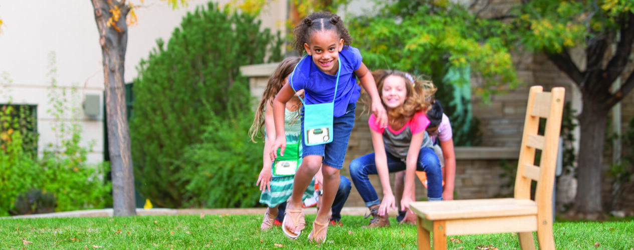 children at a small church play a game outside