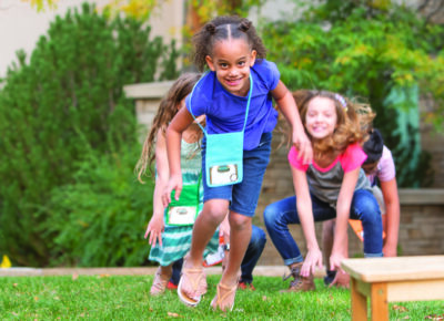 children at a small church play a game outside