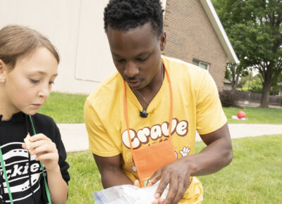 Man serving food in an outdoor ministry setting