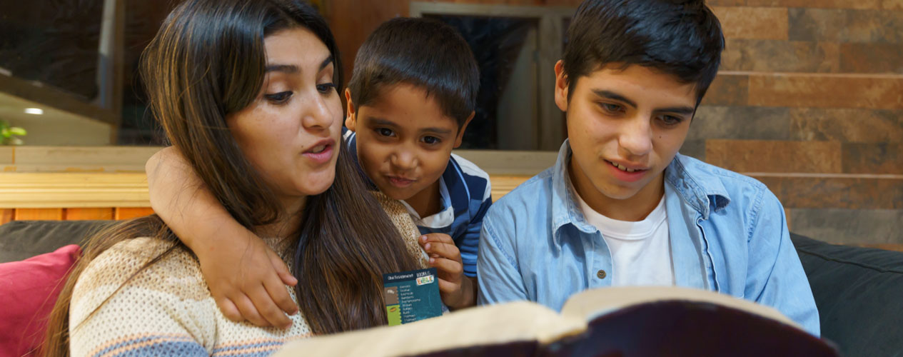 family reading a Bible that has a Books of the Bible bookmark