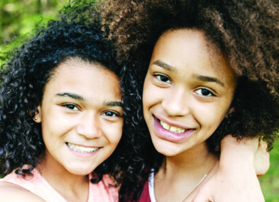 two girls from children's church hugging