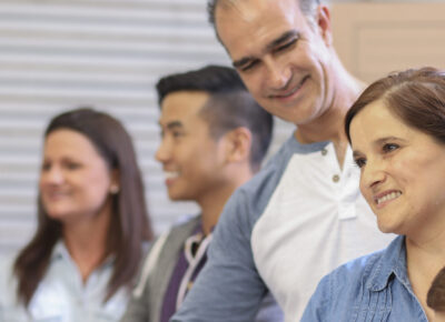 family at a church or community lunch gathering. A woman and man are smiling.